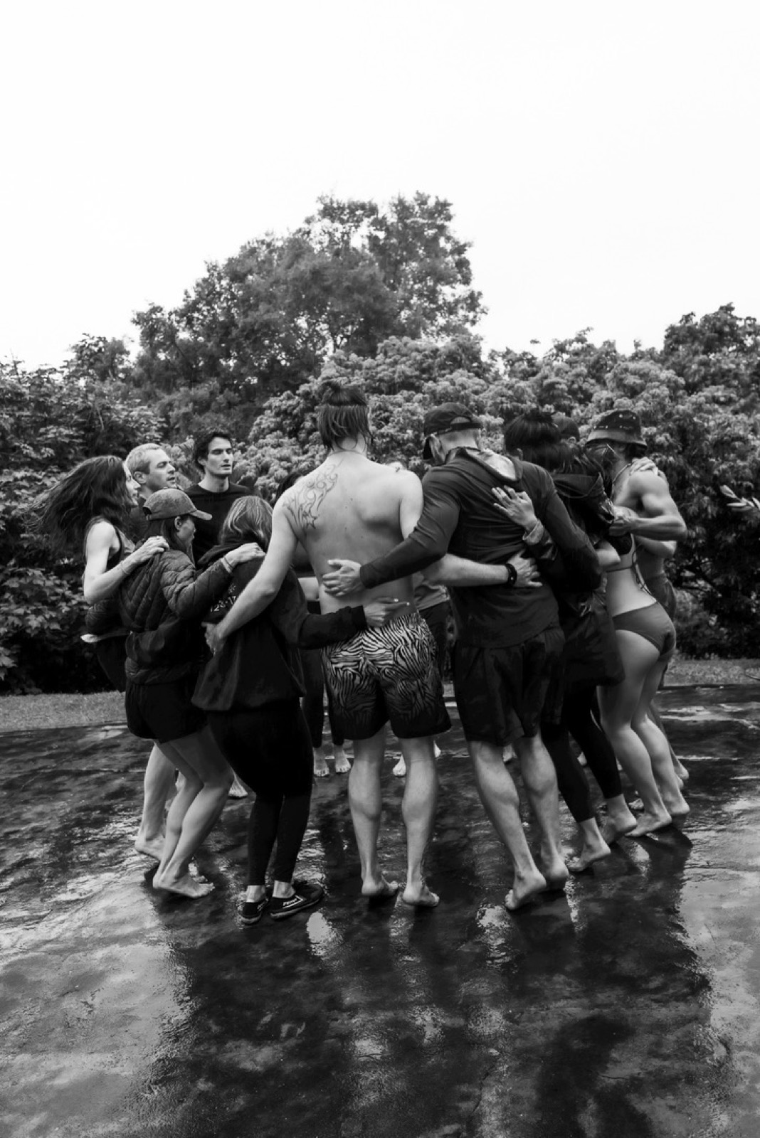 Group embracing in the rain