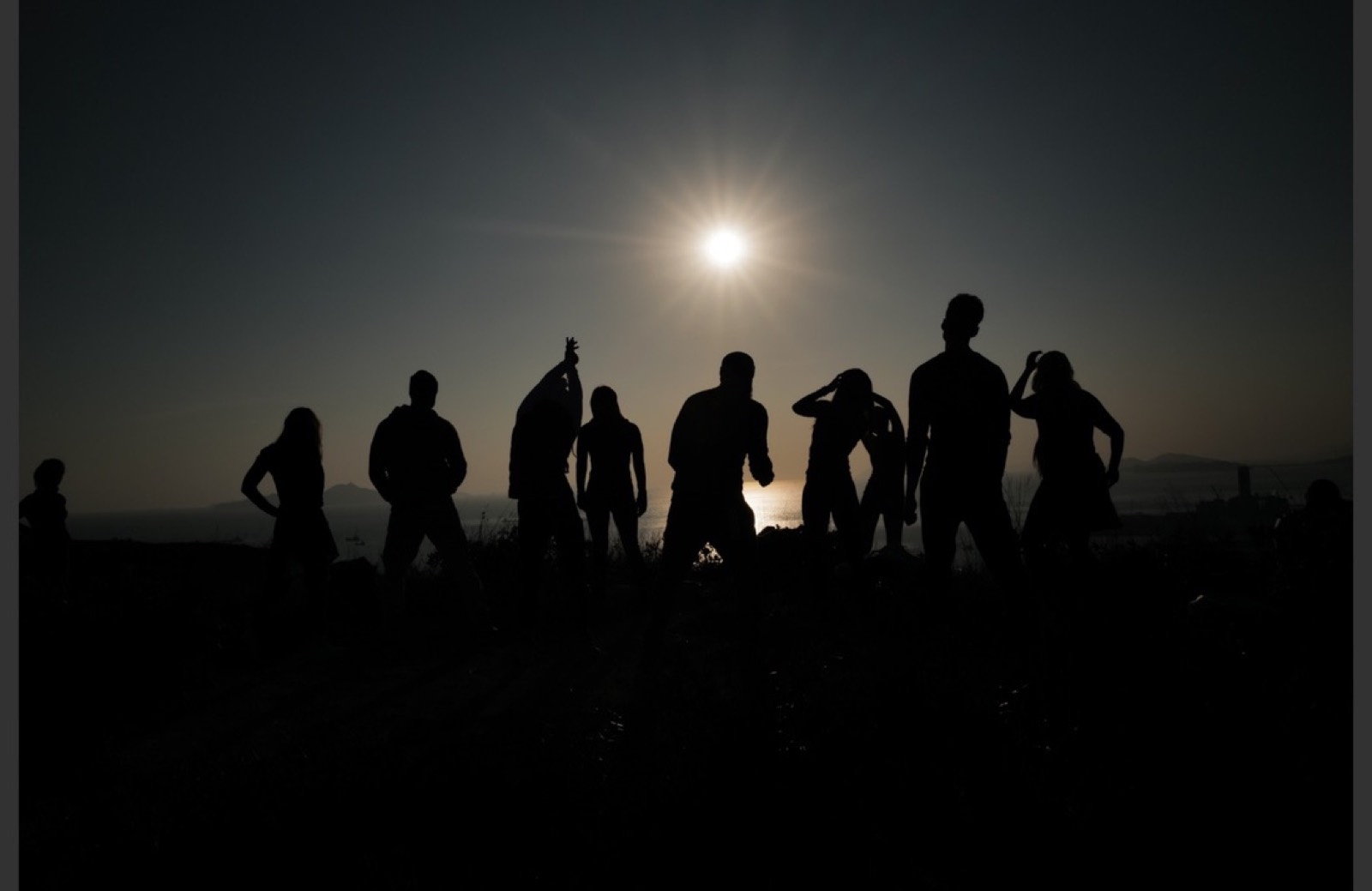Group silhouettes under the open sky
